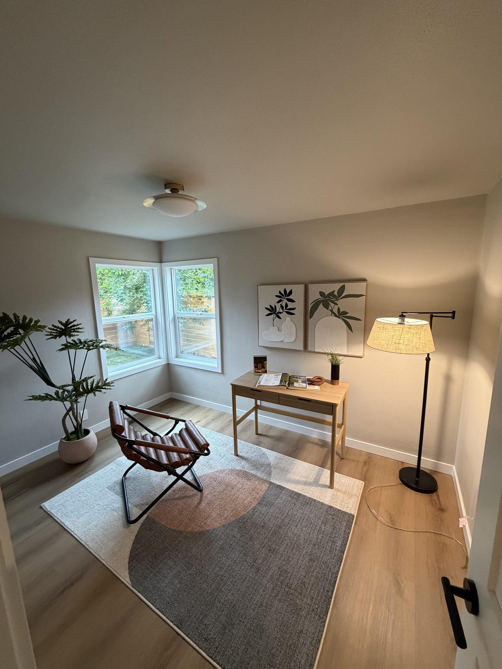 Home office with corner windows and leather chair