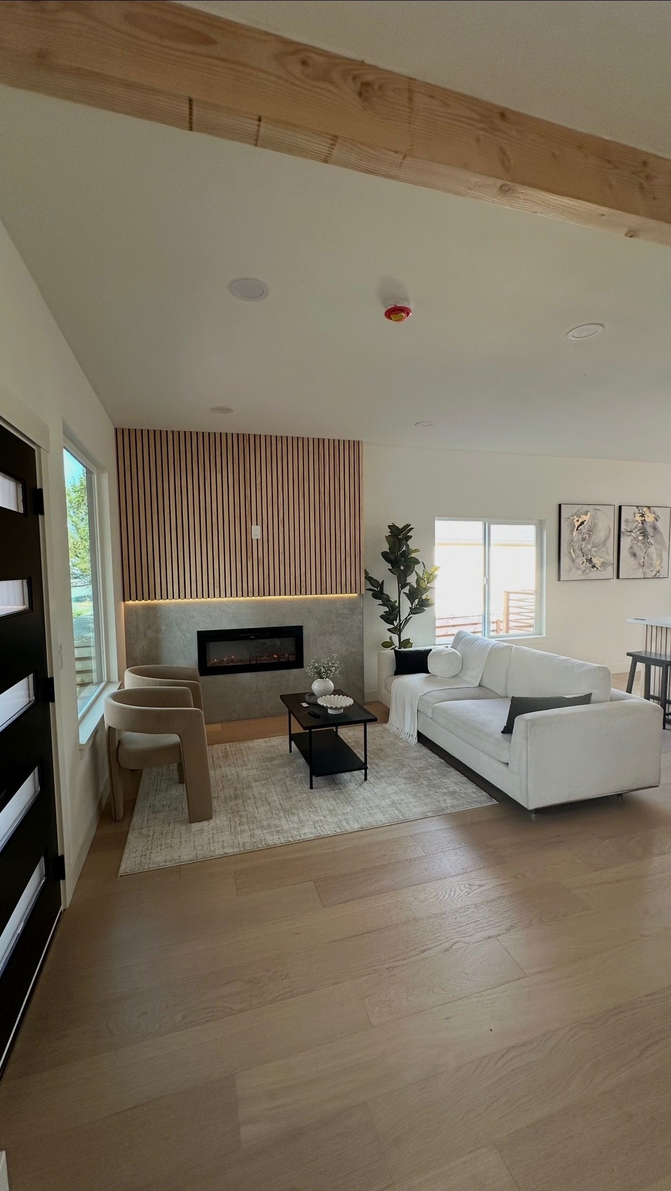 Modern living room with wood slat accent wall and linear fireplace